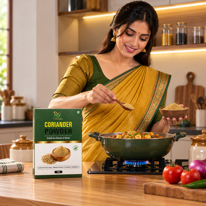 Vaaraahi Coriander Powder being added to a dish in a modern Indian kitchen