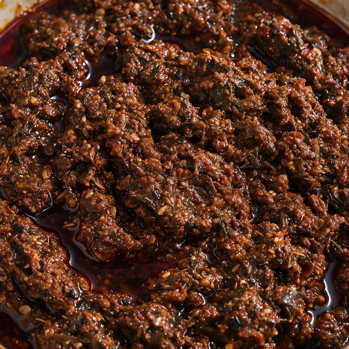 Close-up of Vaaraahi Gongura Pickle showing gongura leaves, spices and traditional pickle texture