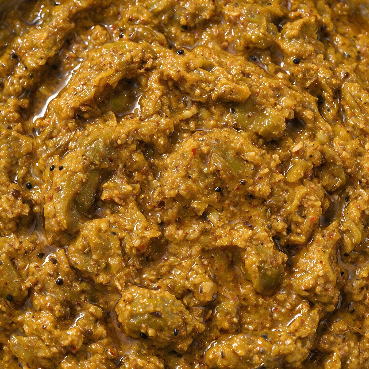 Close-up of Vaaraahi Green Tamarind Pickle with green tamarind pieces and traditional spices