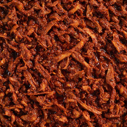 Close-up of Vaaraahi Maagaya Pickle showing sun-dried mango pieces, spices and traditional pickle texture