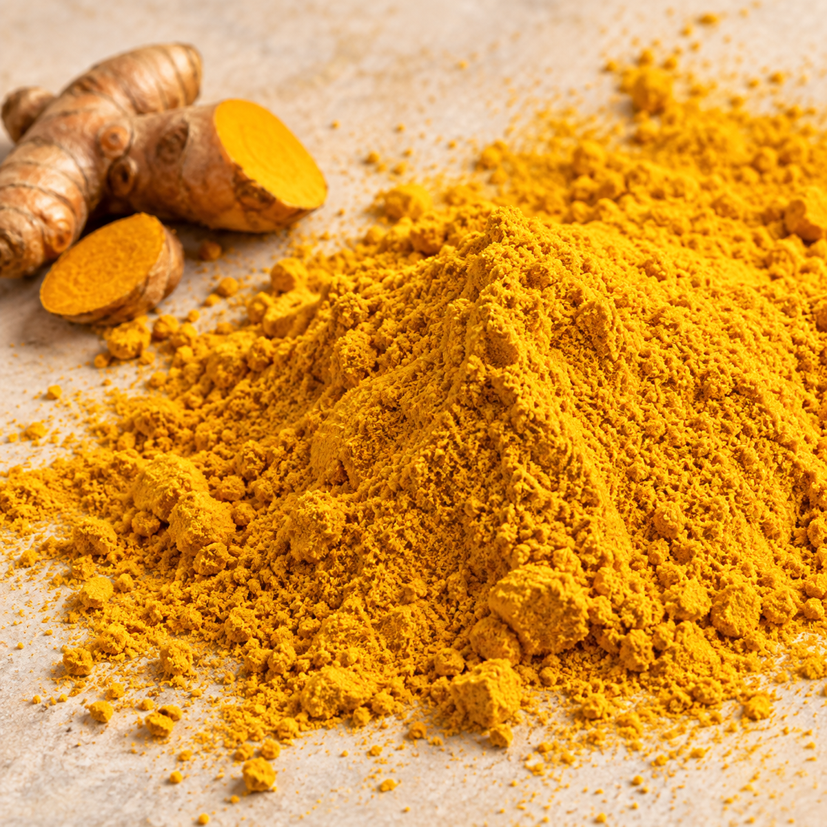 Close-up of Vaaraahi turmeric powder showing its fine texture and turmeric roots